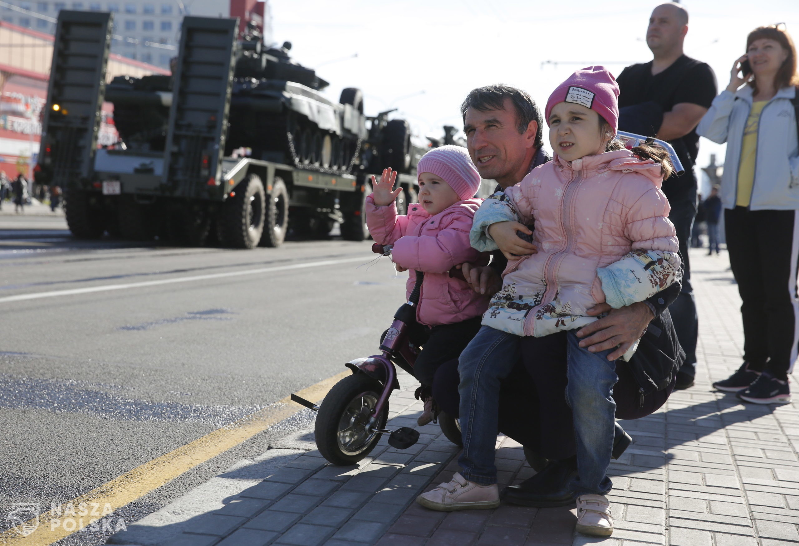 epa08410718 People watch, as column of Belarus army vehicles moves along a street during a Victory Day military parade rehearsal in Minsk, Belarus, 08 May 2020. The parade will take place on 09 May despite World Health Organization recommendations to introduce social distancing in Belarus, postpone large gatherings and cultural events during the growing coronavirus outbreak.  EPA/TATYANA ZENKOVICH 
Dostawca: PAP/EPA.