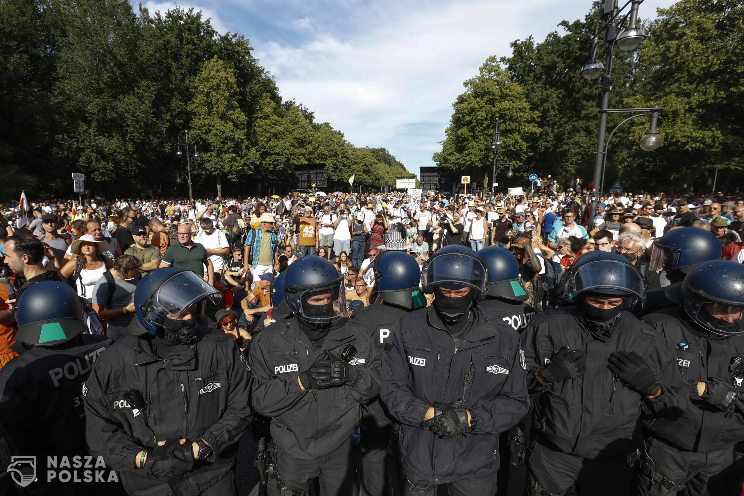 epa08579075 Police form a row in front of demonstrators during a protest against coronavirus pandemic regulations in Berlin, Germany, 01 August 2020. An alliance of right wing groups have called to a democratic resistance demonstration for the first weekend in August. The nationwide rally 'Day of Freedom' will take place 01 August as a protest against the measures imposed by the Government in relation to the coronavirus pandemic. The events are organized by groups of various motives, right wing activists, conspiracy theory believers and more.  EPA/FELIPE TRUEBA 
Dostawca: PAP/EPA.