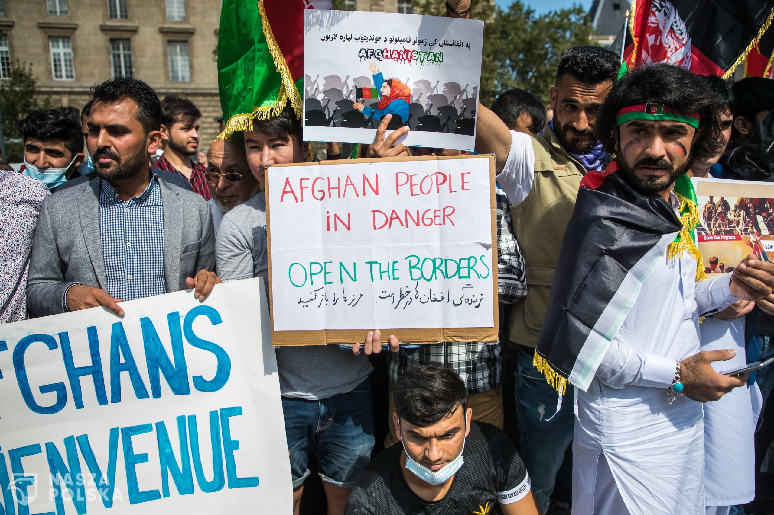 epa09424743 People show posters reading 'Afghan people in danger, open the borders' as French-Afghan community members gather at Republique Square to ask for support to refugees fleeing Afghanistan in Paris, France, 22 August 2021.  EPA/CHRISTOPHE PETIT TESSON 
Dostawca: PAP/EPA.