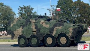 Kołowy transporter Rosomak z żołnierzem w wieżyczce jedzie Wisłostradą podczas Święta Wojska Polskiego