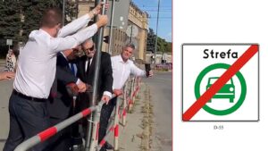 Mężczyźni w białych koszulach wyjmują słupek ze znakiem Strefy Czystego Transportu przy krakowskiej ulicy