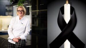 Arleta Żynel w białej bluzie kucharskiej w studyjnej kuchni, obok świeca z czarną wstążką