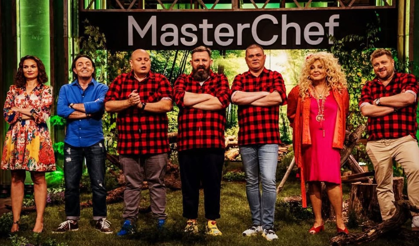 Uczestnicy ósmej edycji MasterChefa w czerwonych koszulach w kratę obok jurorów programu